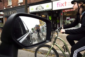 Cyclists ride on the designated Bloor Street bike lanes in Toronto on Thursday, October 12, 2017.
