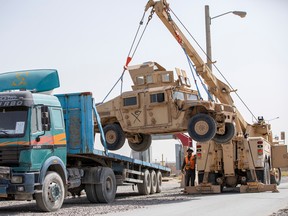 U.S. Army soldiers and contractors load HUMVs as U.S. forces prepare for withdrawal, in Kandahar, Afghanistan, July 13, 2020.