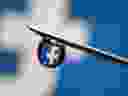 Facebook logo is reflected in a drop on a syringe needle in this illustration photo taken on March 16, 2021. 