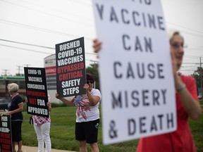 Demonstrators protest COVID-19 vaccinations in Livonia, Mich., on July 24, 2021.