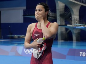 Margaret Mac Neil of Woodstock, Ont. reacts after winning the women's 100m butterfly final. REUTERS/Aleksandra Szmigiel