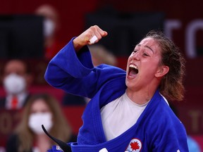 Catherine Beauchemin-Pinard of Canada celebrates after winning bronze against Anriquelis Barrios of Venezuela