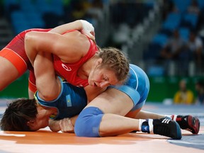 Canada's Erica Elizabeth Wiebe (red) wrestles with Kazakhstan's Guzel Manyurova in their women's 75kg freestyle final match at the 2016 Rio Olympics. Wiebe's win made her one of four gold medalists from Canada in those Games.