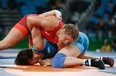 Canada's Erica Elizabeth Wiebe (red) wrestles with Kazakhstan's Guzel Manyurova in their women's 75kg freestyle final match at the 2016 Rio Olympics. Wiebe's win made her one of four gold medalists from Canada in those Games.