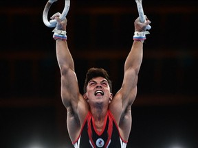 TOPSHOT - Russia's Artur Dalaloyan competes in the rings event of the artistic gymnastics men's qualification during the Tokyo 2020 Olympic Games at the Ariake Gymnastics Centre in Tokyo on July 24, 2021. (Photo by Loic VENANCE / AFP)