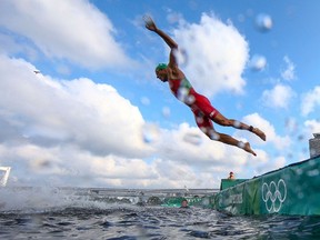 Morocco's Mehdi Essadiq competes in the men's individual triathlon competition during the Tokyo 2020 Olympic Games at the Odaiba Marine Park in Tokyo on July 26, 2021. (Photo by ANTONIO BRONIC / POOL / AFP)