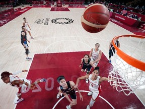 Canada's Shay Colley (L) goes to the basket past South Korea's Jin An (C) in the women's preliminary round group A basketball match between South Korea and Canada during the Tokyo 2020 Olympic Games at the Saitama Super Arena in Saitama on July 29, 2021.