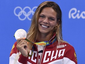 Russia's Yulia Efimova poses with her silver medal on the podium of the Women's 100m Breaststroke during the swimming event at the Rio 2016 Olympic Games  August 8, 2016.
