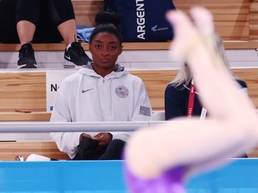 Simone Biles of the United States watches from the stands.