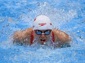 Canada's Maggie Mac Neil won an Olympic gold in the 100m butterfly near the start of the swim meet in Tokyo.