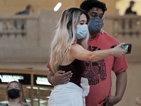 People wearing masks pose in Grand Central Terminal on July 27, 2021 in New York City. Due to the rapidly spreading Delta variant, the Centers for Disease Control and Prevention has recommended that fully vaccinated people begin wearing masks indoors again in places with high Covid-19 transmission rates.
