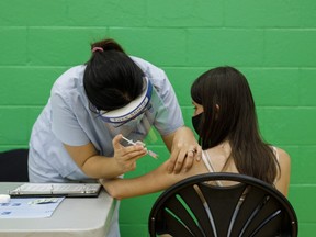 An adolescent receives a dose of the Pfizer-BioNTech Covid-19 vaccine at a clinic in Toronto, Ontario, Canada, on Wednesday, May 19, 2021. Canada is the second country to allow use of the Pfizer vaccine for adolescents, after Algeria.