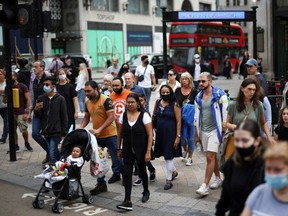 People walk through Oxford Circus, amid the coronavirus disease (COVID-19) outbreak, in London, Britain, July 26, 2021.