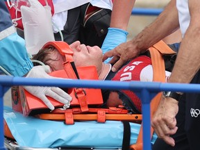 Connor Fields of the United States receives medical attention.