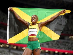 TOKYO, JAPAN - JULY 31: Elaine Thompson-Herah of Team Jamaica celebrates after winning the gold medal in the Women's 100m Final on day eight of the Tokyo 2020 Olympic Games at Olympic Stadium on July 31, 2021 in Tokyo, Japan.