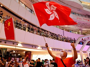 Fans of Hong Kong swimmer Siobhan Haughey and pro-China supporters react as they watch the live broadcast of the Tokyo 2020 Olympic Summer Games women's 100m freestyle final at a shopping mall in Hong Kong, China. July 30, 2021.