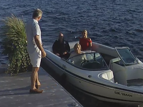 A screenshot of security video showing Linda O'Leary, wife of celebrity investor Kevin O'Leary, driving their speedboat to a neighbour's cottage on the evening of a fatal boat crash. Kevin is in a black shirt, Linda in blue jeans and a white top and Allison Whiteside, an O'Leary family friend, is in red top.