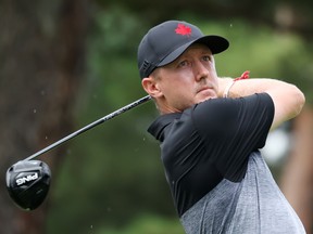 Mackenzie Hughes of Team Canada plays his shot from the 18th tee during the first round of the Men's Individual Stroke Play.
