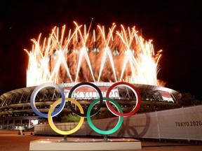 TOKYO, JAPAN - JULY 23: The Olympic Rings are seen outside the stadium as fireworks go off during the Opening Ceremony of the Tokyo 2020 Olympic Games at Olympic Stadium on July 23, 2021 in Tokyo, Japan.