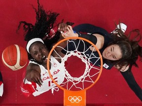 Laeticia Amihere of Canada in action at the rim with Park Ji Su of South Korea.