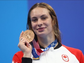 Penny Oleksiak of Canada poses with her bronze medal.