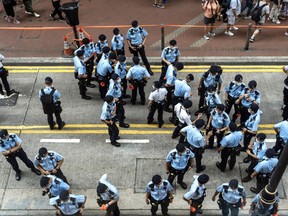 Police officers stand guard in the Causeway Bay area of Hong Kong, China, on Thursday, July 1, 2021.