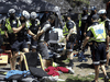 Toronto Police arrest a man after being met with resistance as they prepare to enter a tent while by-law officers moved in on the homeless encampment outside Lamport Stadium on Wednesday July 21, 2021.