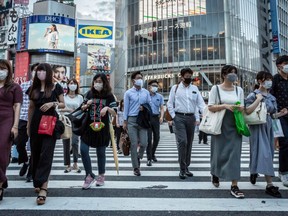 People wearing face masks cross Shibuya crossing on July 27, 2021 in Tokyo, Japan. Tokyo metropolitan government reported 2,848 new coronavirus cases on Tuesday, the highest number of infections recorded so far for the city.