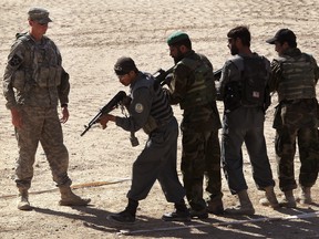 A U.S. Army advisor trains Afghan National Police in close quarters battle techniques at Forward Operating Base Ramrod in Kandahar, Afghanistan, in 2010.