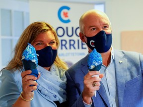 Canada's opposition Conservative party leader Erin O'Toole holds an ice-cream while standing next to his wife Rebecca O'Toole during a visit to the riding of Charlottetown, Prince Edward Island, Canada, August 28, 2021.