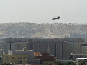 An American Chinook military helicopter flies above the U.S. Embassy in Kabul on Aug. 15.