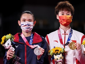 Silver medalist Tai Tzu-Ying of "Team Chinese Taipei" (Taiwan), left, stands on the podium next to gold medallist Chen Yu Fei of China during the medal ceremony for the Women’s Singles badminton event on day nine of the Tokyo 2020 Olympic Games at Musashino Forest Sport Plaza on Aug. 1.