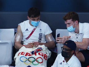 TOKYO, JAPAN - AUGUST 02: Tom Daley of Team Great Britain knits during the Men's 3m Springboard Preliminary Round on day ten of the Tokyo 2020 Olympic Games at Tokyo Aquatics Centre on August 02, 2021 in Tokyo, Japan. (Photo by Clive Rose/Getty Images)