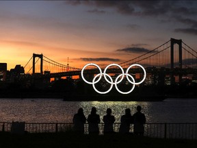TOKYO, JAPAN - AUGUST 04: A general view of the Olympic rings installation and Rainbow Bridge as the sun sets on day twelve of the Tokyo 2020 Olympic Games at Odaiba Marine Park on August 04, 2021 in Tokyo, Japan.
