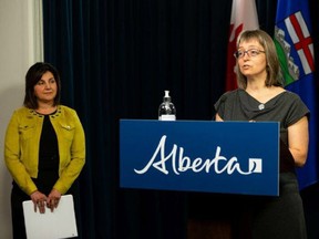 Alberta chief medical officer of health Dr. Deena Hinshaw (right) speaks about back-to-school guidance and the postponement of the relaxation of COVID-19 regulations for six weeks next to Education Minister Adriana LaGrange during a press conference at the Alberta Legislature in Edmonton, on Friday, Aug. 13, 2021.