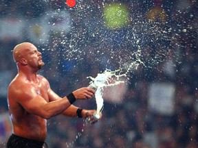 Don't try his at home: Stone Cold Steve Austin pops open a couple of cans of beer after beating an opponent.