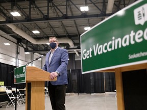 Premier Scott Moe speaks to media after a tour of the COVID-19 mass immunization clinic and drive-thru immunization space at International Trade Centre in Regina on Thursday Feb. 18, 2021. The province also has mobile immunization vehicles to distribute the vaccine to remote communities.