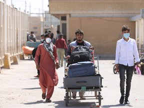 Afghan nationals enter Iran at the Dowqarun border crossing between Iran and Afghanistan, Razavi Khorasan Province, Iran, on Aug. 29, 2021.