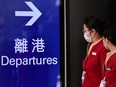 Cathay Pacific employees walk through Hong Kong International Airport on October 21, 2020.