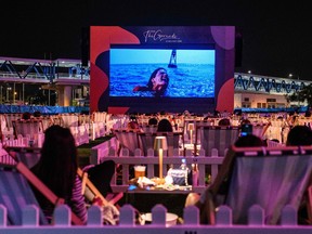 People watch a film at the city's first socially distanced outdoor entertainment venue in Hong Kong on Nov. 10, 2020, which has 100 socially distanced private 'pods', each seating two or four people to respect social distancing measures due to the COVID-19 pandemic.