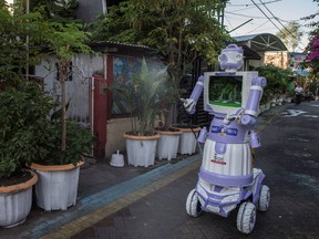 A disinfection robot named Delta, created from recycled household goods by neighbourhood resident Aseyan, who goes by one name only, is seen during a demonstration in Surabaya on July 28, 2021.