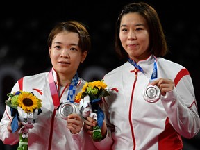 China's Jia Yifan (R) and China's Chen Qingchen pose with their women's doubles badminton silver medals at a ceremony during the Tokyo 2020 Olympic Games.