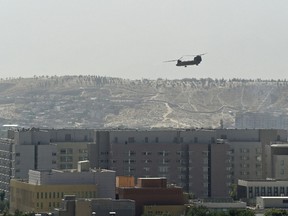 A U.S. military helicopter is pictured flying above the U.S. embassy in Kabul on Aug. 15, 2021.