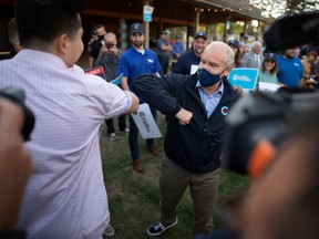 Conservative Leader Erin O'Toole elbow bumps a supporter during a campaign stop in Saskatoon on Aug. 20.