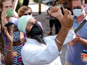 New Democratic Party leader Jagmeet Singh (R) takes a selfie with volunteers in Montreal, Quebec on August 23, 2021.