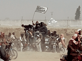Supporters of the Taliban carry the group's signature white flags in the border town of Chaman, Pakistan.