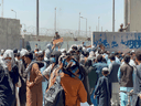 U.S. soldiers watch as crowds of people gather outside the airport in Kabul, Afghanistan, August 26, 2021.