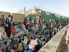 Crowds of people wait outside the airport in Kabul, Afghanistan August 25, 2021.