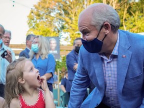 Conservative party leader Erin O'Toole looks at a kid at the 737 restaurant during his election campaign tour, in Quebec City, Quebec, Canada August 18, 2021.