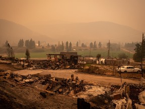 Thick smoke fills the air and nearly blocks out the sun as a property destroyed by the White Rock Lake wildfire is seen in Monte Lake, east of Kamloops, B.C., on, Aug. 14.